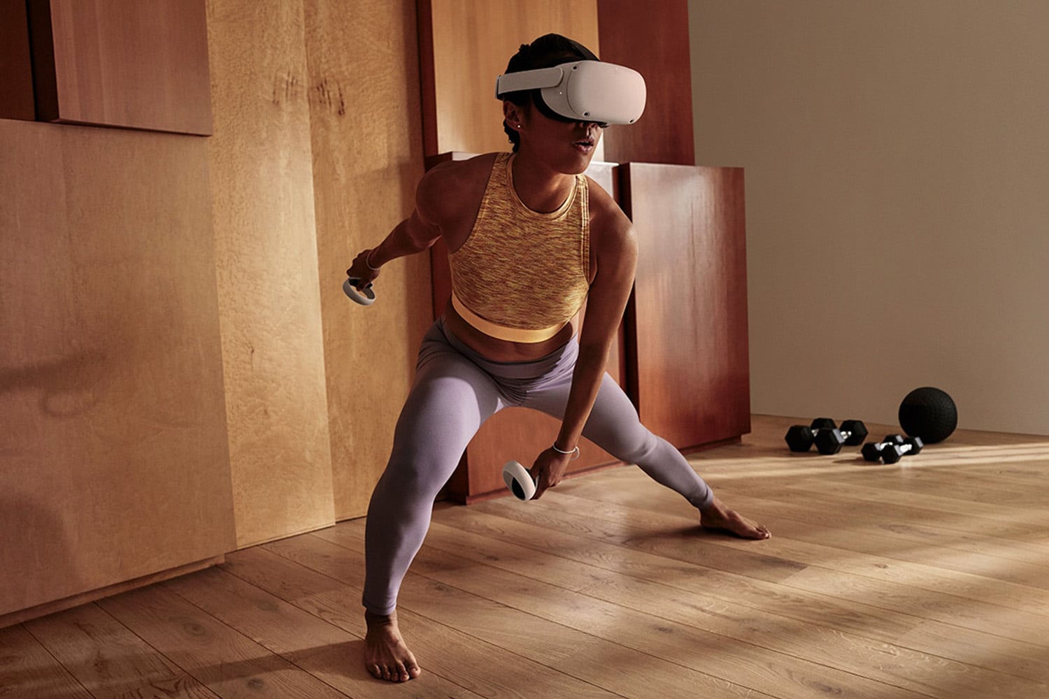 A person working out in a living room with an interactive mixed reality fitness interface
